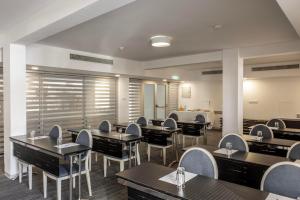 a dining room with tables and chairs at Park Beach Hotel in Limassol