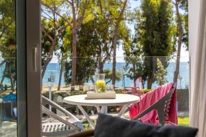 a table and two chairs in front of a window at Park Beach Hotel in Limassol