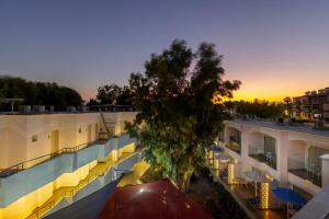 an apartment building with a tree in the middle at Park Beach Hotel in Limassol
