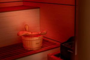 a wooden bucket with a pair of shoes in a room at Park Beach Hotel in Limassol