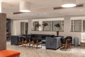 a living room with a large couch and chairs at Park Beach Hotel in Limassol