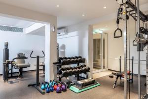 a gym with weights and equipment in a room at Park Beach Hotel in Limassol