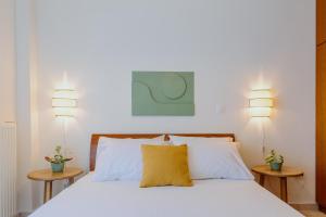 a bedroom with a bed with a yellow pillow at The Green - Svolio Hospitality in Komotini