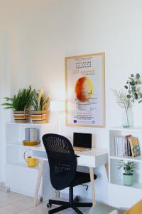 a desk with a chair and a laptop on it at The Green - Svolio Hospitality in Komotini +18 photos