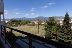 a balcony with a view of trees and mountains at The Green - Svolio Hospitality in Komotini