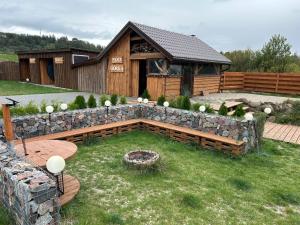 a backyard with a stone wall and a building at Apartament Pod Górką Gołdap in Gołdap +19 photos