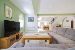 a living room with a couch and a tv at House Anna in Drage