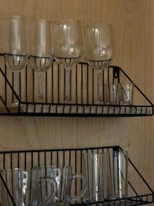 a group of wine glasses on a shelf at 17HILLS Cottage in Acharistsqali +74 photos