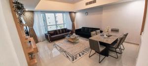 a living room with a table and a couch at Royal Home in Abu Dhabi