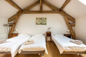 a room with two beds in a attic at Ferme de Pontaly in Bailly