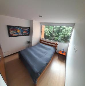 a bedroom with a bed in a room with a window at Lujoso y Economico Apartamento in Envigado +57 photos