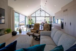 a living room with a couch and chairs at Beautiful Haven - Stunning Luxury Home - Queenstown - NEW!! in Queenstown