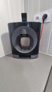a computer monitor sitting on a counter with a charger at La Mezzanine - 2-4 pers - Centre-Ville in Brassac-les-Mines