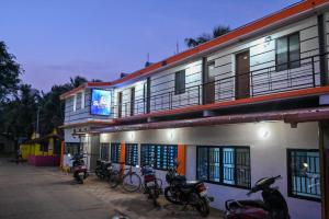 a group of motorcycles parked in front of a building at The Shadaxari Nilaya in Gokarna