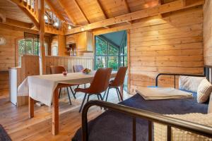 a dining room in a log cabin with a table and chairs at Blockbohlen-Haus auf Hof Verchen in Verchen +18 photos
