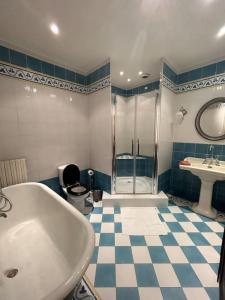 a bathroom with a shower and a tub and a sink at La maison n1 Arles terrasse in Arles +45 photos
