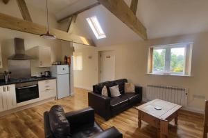 a living room with a couch and a table at 4 Abbey View, Battle East Sussex in Battle