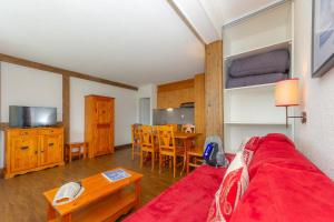 a living room with a bed and a dining room at Résidence Goélia Le Sornin in Autrans +7 photos
