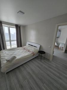 a bedroom with a bed and a large window at ЖК Яровиця in Lutsk +16 photos