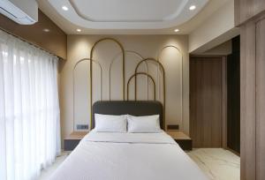 a bedroom with a large bed with white pillows at Orbit Serviced Apartments in Mumbai +58 photos