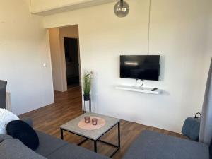 a living room with a couch and a table at Lakeside Apartments - A in Egilsstaðir