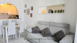 a living room with a couch and a table at Laguna Beach Paradise - Alojamientos La Torre in Torrox Costa
