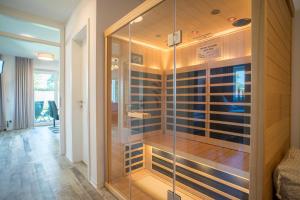 a glass walk in shower in a room at Fewo Lüttje Parl in Hooksiel