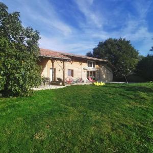 a house with a large yard in front of it at Longère bressane. in Domsure