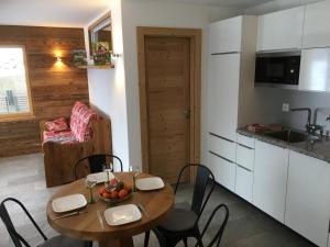 a kitchen and dining room with a table and chairs at Apartment Chalet Mont Noble, 4 Vallées in Hérémence
