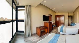 TV a/nebo společenská místnost v ubytování Stay Inn Pyramids Hotel