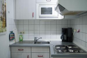 a small kitchen with a sink and a microwave at Ferienwohnung Boje 4 in Schillig +7 photos