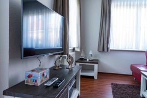 a living room with a large flat screen tv at Ferienwohnung Krabbe in Hooksiel