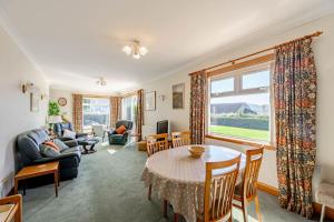 a living room with a table and chairs at Anthony House in Kippford