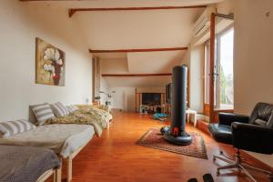 a living room with a couch and a fireplace at Le Guiguet - Mas provençal avec piscine pour 10 in Vedène