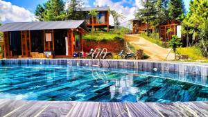 a large swimming pool in front of a house at Lam Ecolodge Mu Cang Chai in Nam Khat