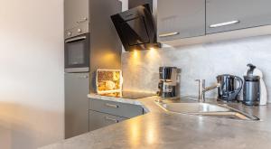 a kitchen with a sink and a counter top at Ferienwohnung Ebbe in Hooksiel