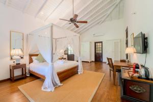 a bedroom with a bed with a ceiling fan at Lotus Estate Colombo in Colombo +57 photos