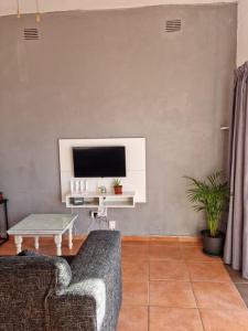 a living room with a couch and a tv at Home away sea view in Margate
