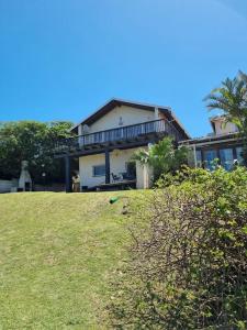a large house on top of a grassy hill at Home away sea view in Margate