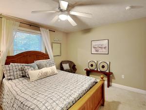 a bedroom with a bed and a ceiling fan at Heavenly Grove in Oakland