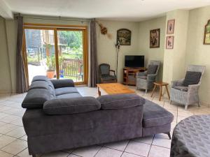 ein Wohnzimmer mit einem großen Sofa und Stühlen in der Unterkunft Chalet 18 personnes 8 chambres aux 3 vallees, menuires in Saint-Marcel