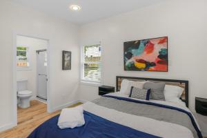 a bedroom with a bed and a painting on the wall at Stylish 4BR Haven: Serene Backyard and Fire Pit in Charlotte