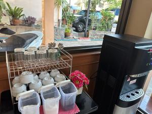 a bunch of mason jars on a table in a kitchen at ปะการังแมนชั่น in Udon Thani