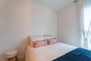 a bedroom with a bed with two pillows on it at La Reposée - Appt à 25 min de Paris in Garges-lès-Gonesse