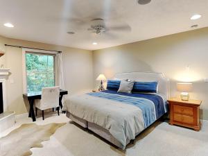 a bedroom with a bed and a desk and a window at Heavenly Grove in Oakland