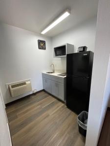 a kitchen with a black refrigerator in a room at Motel 6 Artesia, NM in Artesia +16 photos