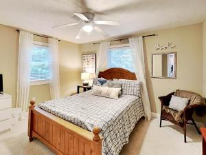 a bedroom with a bed and a ceiling fan at Heavenly Grove in Oakland
