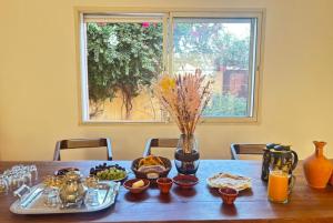a wooden table with food on it with a window at Villa contemporaine - 6 chambres - piscines et jacuzzi in Marrakech