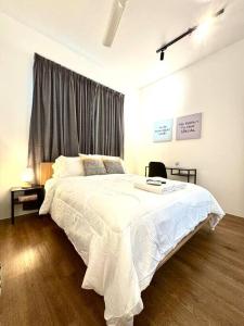 a bedroom with a large white bed with a window at Rumakita #4 Vista Alam Top Floor Studio in Shah Alam