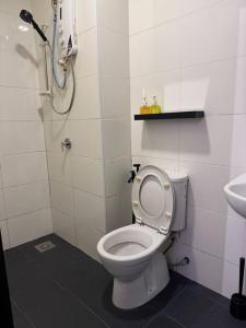 a bathroom with a white toilet and a sink at Rumakita #4 Vista Alam Top Floor Studio in Shah Alam +14 photos